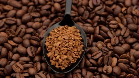 Instant coffee in black spoon and coffee beans on background rotation Stock Footage 140903560