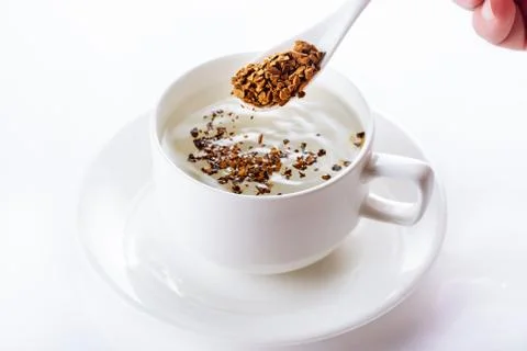 Instant coffee is filled in a cup with hot water. Close up. Selective focus. Stock Photos