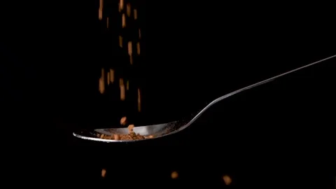 Instant coffee granulate falling in slow motion on spoon isolated background Stock Footage 170435452