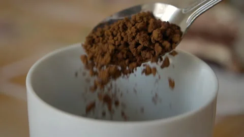 Instant Coffee Pieces Falling From Spoon in Slow Motion in Cup. Fresh Morning Video stock 145827410