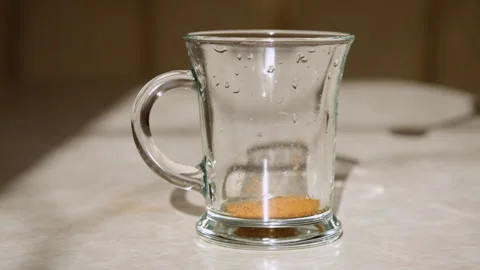 Instant coffee is poured into a cup, slow motion. Stock Footage 236714954