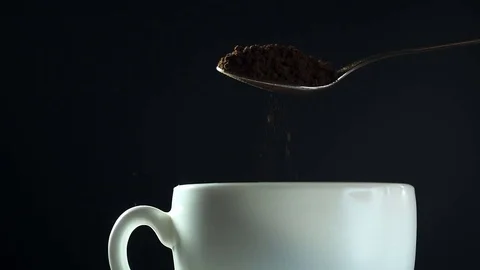 Instant coffee pouring from spoon to white mug, close-up slow motion hd video Stock Footage 72400922
