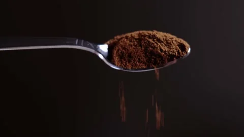 Instant coffee spoon close-up. slowly pouring coffee into a cup Stock Footage 148036056