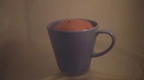 Instant cup cake in microwave Stock Footage 49569061