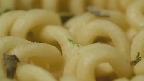 Instant dry pasta rotating on the table in macro Stock Footage 127525260