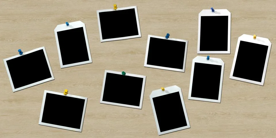 Instant frames hang on wall with colored pins Stock Photos