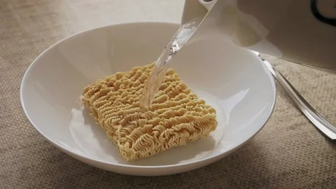 Instant noodles are poured with boiling water Stock Footage 155486015