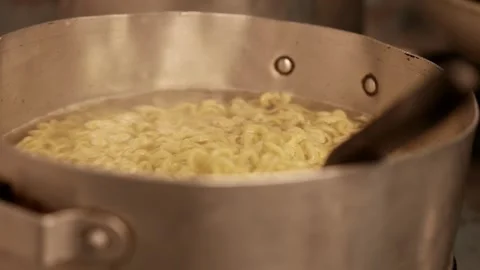 Instant noodles boiling. A steaming pot of spaghetti. Ramen noodles boiling Stock Footage 345941903