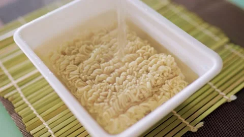 Instant noodles in the process of being prepared. A behind-the-scenes look at Stock Footage 231072434