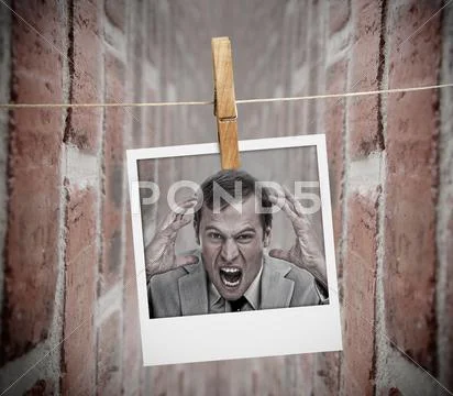 Instant photo of angry business man hung with peg Stock Photos