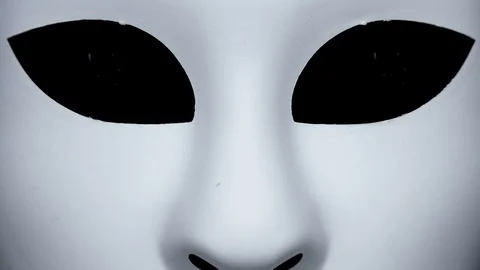 Instead of the eye of the white mask appears gun Stock Footage 83223232