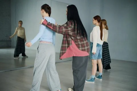 Instructing Dance Class with Diverse Students in Studio Stock Photos