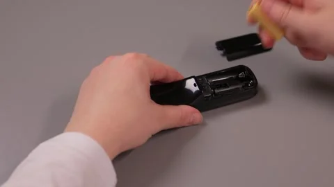 Instructional process of replacing battery in small electronic device Stock Footage 347880402