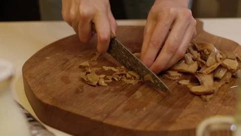 Instructions for making pizza. Step Four Cut the pickled mushrooms into pieces Stock Footage 155069577