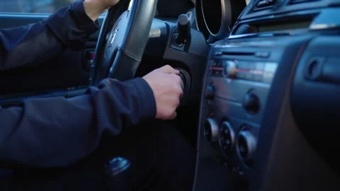 Instructions for novice driver how to start automobile.Insirting key, turning on Stock Footage 276895321
