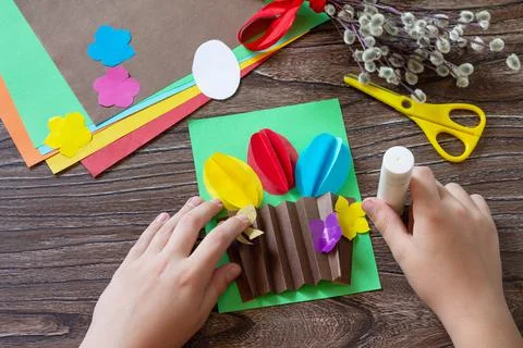 Instructions, step 8. Easter congratulation card with basket easter eggs. Han Stock Photos
