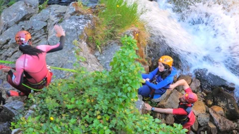 Instructor Adults And Kid Rappelling A Huge Waterfall Video stock 91998873
