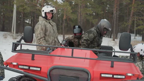 Instructor aids riders before offroad adventure. Instructors and crew perform Stock Footage 337828529