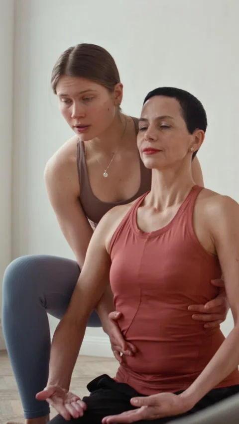 Instructor Aligning Yoga Posture Stock Footage 329679976