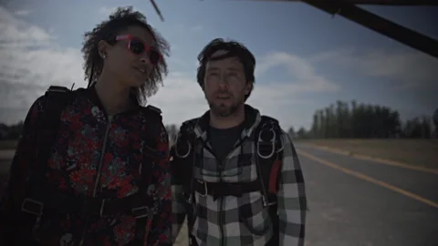Instructor and student prepare to jump on a plane. Stock Footage 166247958