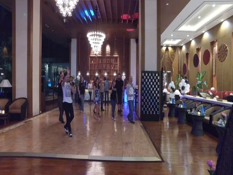 Instructor and students do dance class in hotel Vidéo 70301647