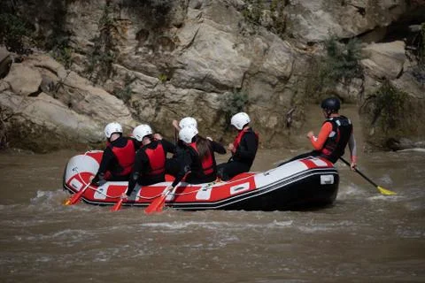 Instructor and team practicing rafting down the river as a seasonal adventure Stock Photos
