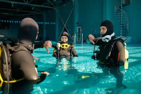 Instructor and two divers, lesson in diving school Stock Photos