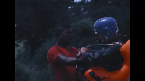 Instructor attach harness to astronaut Shepard during parasail training - 1968 Stock Footage 104331103
