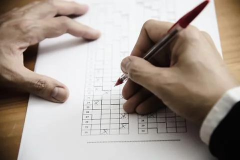 Instructor checking multiple choices answer sheet exam - education people wor Stock Photos