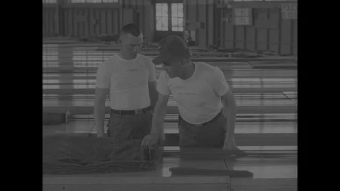 Instructor checking soldiers parachute - 1967 Stock Footage 118316151
