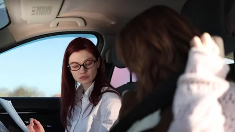 Instructor checks student fastening seat belt Video stock 332872044