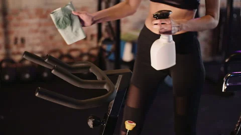 Instructor With Cloth And Sprayer At Gym Stock Footage