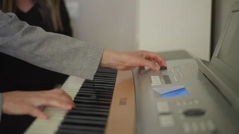 Instructor coaching practice. Mentor assists pupil with keyboard. Supportive Stock Footage 346550884