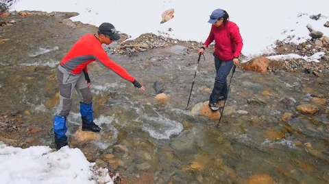 The instructor controls the transition stream fording Stock Footage 50767234