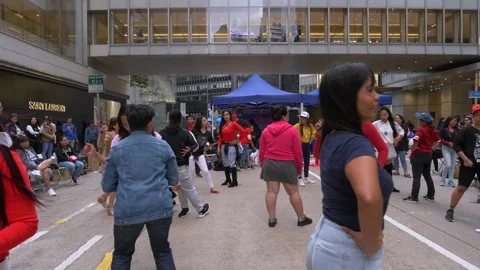 Instructor coordinating dancing people for a flashmob on the street in China Stock Footage 146590077