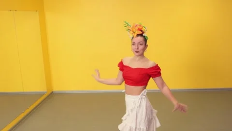 Instructor demonstrates salsa technique to a young female student in class Stock Footage 336547603