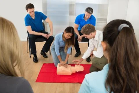 Instructor Demonstrating Cpr Chest Compression On A Dummy Foto stock