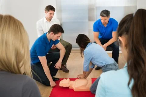 Instructor Demonstrating Cpr Chest Compression On A Dummy Stock Photos