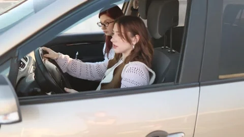 Instructor evaluates student during driving lesson Video stock 332871903