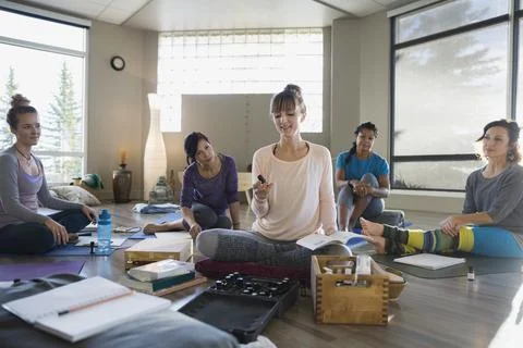 Instructor explaining essential oils at yoga retreat Stock Photos