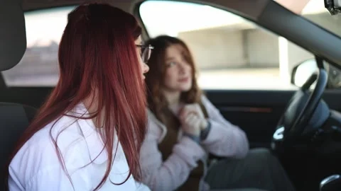 Instructor explains step to student in car Video stock 332872120