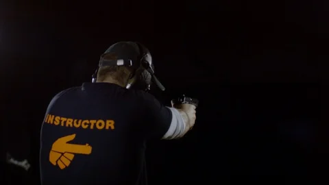 Instructor firing two bullets, Ultra Slow Motion Stock Footage 86584627