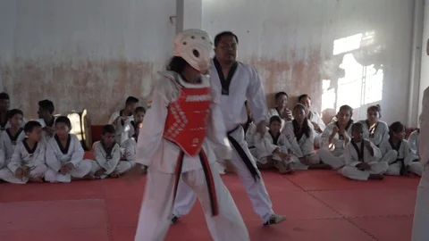 Instructor gives start signal, two women practicing Taekwondo sparring, Stock Footage 113415767