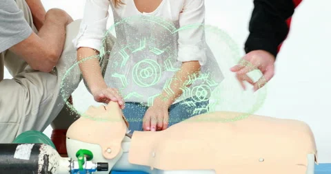 Instructor guiding child practicing chest compressions on CPR mannequin with Stock Footage 316085993
