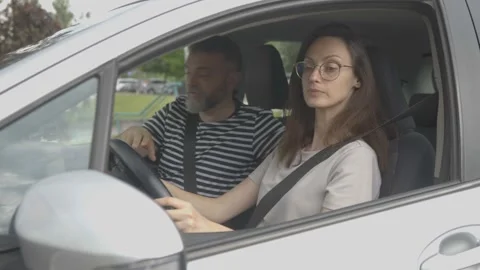 Instructor guiding student to drive car Stock Footage 337833225