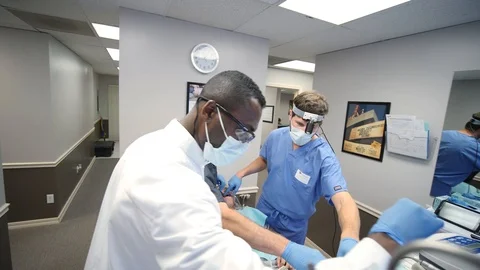 Instructor helps dentists with threatening a patient Stock-Footage 127000956