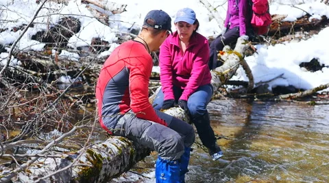 Instructor helps tourists crawling on the trunk of a fallen tree Stock Footage 50769578