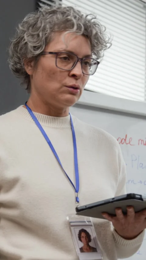 Instructor Holding Digital Tablet while leading Class Vertical Stock Footage 329002846