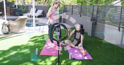 Instructor inviting fitness trainee into hamstring stretching while ring light Stock Footage 320416178