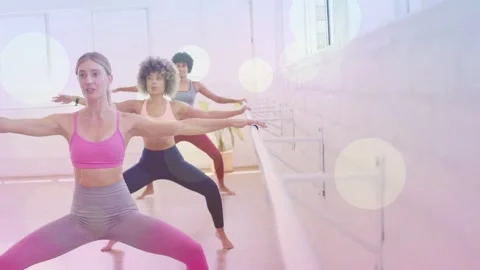 Instructor leading barre class, initiating mirroring plies for alignment, camera Stock Footage 334322290